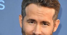 Ryan Reynolds in a classic tuxedo with a bowtie, showcasing his charming smile and stylish look at a red carpet event.