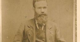 Portrait of a bearded man in 19th-century attire, possibly Hugh Mckinley, seated with decorative fringed cushion.