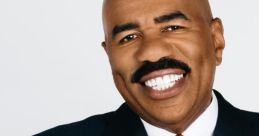 Steve Harvey smiling confidently in a tailored suit with an orange tie, showcasing his signature style and charismatic persona.