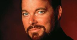 Jonathan Frakes as Commander Riker in Star Trek, showcasing iconic Starfleet uniform and distinct facial features.