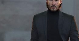 John Wick stands confidently in a dimly lit setting, ready for action with a gun in hand, showcasing his intense character.