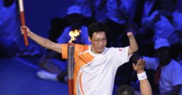 Zhang Hongwei celebrates the Paralympic spirit, passing a torch to a wheelchair athlete at the Beijing 2008 opening ceremony.