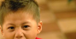 Young boy in a red shirt expressing intense anger, shouting loudly in a playful, lively environment.