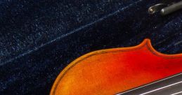 Close-up of a beautifully crafted violin showcasing rich, vibrant wood tones and smooth strings inside a plush case.