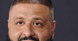 DJ Khaled smiles confidently, showcasing his signature beard and stylish jacket, embodying success in the music industry.