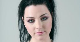 Amy Lee of Evanescence with dark hair and striking green eyes, wearing a black tank top and heart-shaped necklace.