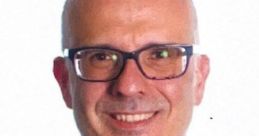 Professional portrait of Roke Julio Garcia Monsalve, smiling, wearing glasses, with a striped shirt and a tie.