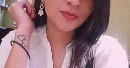 Young woman with long dark hair wearing a white blouse and statement earrings, showcasing a stylish look and confidence.