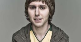 Jay Cartwright from *The Inbetweeners*, wearing a yellow jersey and gray jacket, showcasing his distinct style.