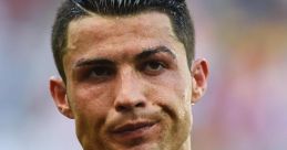 Cristiano Ronaldo wearing a Portugal jersey, displaying determination and focus during a football match.