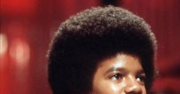 Young Michael Jackson performing with his signature hairstyle, capturing the essence of 1970s music culture.