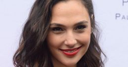 Gal in a stylish pink blazer and red top, smiling confidently at a public event, showcasing her beauty and charm.