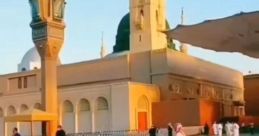 Pristine courtyard of a mosque at sunset, reflecting warm light with people in traditional attire strolling nearby.