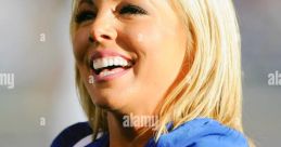 Cheerful Melany Leija smiles during a lively sports event, showcasing her team spirit in vibrant blue attire.