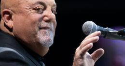 Billy Joel performing live, engaging with fans from the stage, showcasing his iconic music talent and charisma.