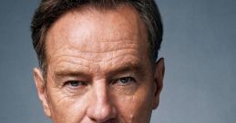 Close-up portrait of Bryan Cranston in a plaid shirt, showcasing his intense expression and captivating presence.