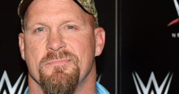 Stone Cold Steve Austin poses confidently, wearing a blue shirt and camo hat, showcasing his iconic wrestling persona.