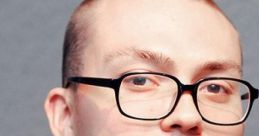 Anthony Fantano, music critic, smiling with glasses, showcasing his signature style and approach to music reviews.