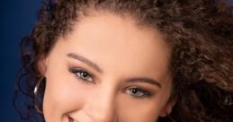 Smiling woman with curly hair wearing hoop earrings and a gray top, showcasing vibrant personality and charm.