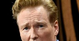 Conan O'Brien speaking during an event, showcasing his signature hair and expressive facial demeanor.