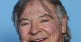 Frank Welker smiles at a public event, showcasing his signature charm and talent as a legendary voice actor.