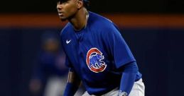 Sergio Alcantara in action, fielding position, wearing Chicago Cubs gear during a night game at the ballpark.