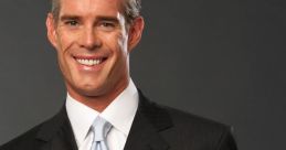 Joe Buck in a dark suit and light tie, smiling confidently with open hands, showcasing his charismatic personality.