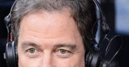 Kevin Harlan passionately commentates during a live sports broadcast, wearing a headset and microphone.