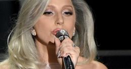 Lady Gaga passionately singing into a microphone, showcasing her stunning fashion and signature long hair.