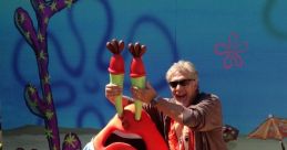 Mr. Krabs character poses playfully with Clancy Brown at a lively event, showcasing their fun interaction and vibrant backdrop.