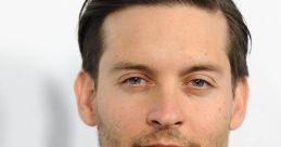 Tobey Maguire in a stylish suit, showcasing a sophisticated look at a red carpet event. Actor and filmmaker.