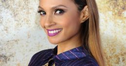 Arika Dixon showcases vibrant fashion in a colorful, artistic blouse, smiling against a textured background.