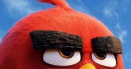 Close-up of Red from The Angry Birds Movie, showcasing his iconic angry expression and vibrant red feathers against a blue sky.