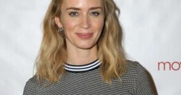 Emily smiles, showcasing a chic outfit with a patterned top, at a promotional event against a branded backdrop.