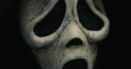 Iconic Ghostface mask from SCREAM (2022), featuring haunting eyes and an open mouth, embodying classic horror elements.