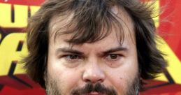 Jack Black poses for the camera in a casual black shirt featuring a panda design, showcasing his signature style.