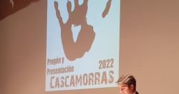 Iván Ariza speaking at the 2022 Cascamorras event, presenting and celebrating cultural traditions with enthusiasm.