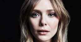 Portrait of Elizabeth Olsen with tousled hair and natural makeup, showcasing a captivating expression against a dark background.