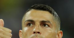 Cristiano Ronaldo focused and determined, giving a thumbs up during a match, showcasing his competitive spirit.