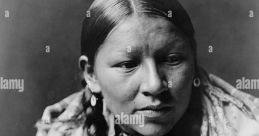 Portrait of a Native American woman adorned in traditional jewelry and clothing, highlighting cultural heritage and identity.