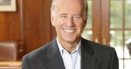 Joe Biden smiling in a dark suit, seated in an elegant room with wooden decor, showcasing a confident and approachable demeanor.