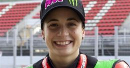 Ana Ribes Carrasco, smiling racer in racing gear, showcasing her passion for motorsports and motorcycle racing.