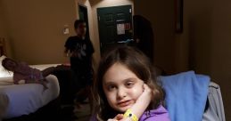 Young girl sitting at a table with pizza slice, enjoying family time in a cozy hotel room. Perfect for memorable moments.