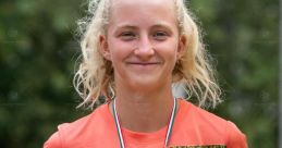 Greta Buda proudly holding a trophy and medal, celebrating her victory at a tennis tournament.