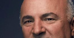 Kevin O'Leary, renowned entrepreneur and TV personality, poses in a formal suit, exuding confidence and charisma.