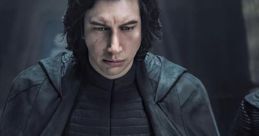 Kylo Ren stands solemnly, looking down at his cracked helmet, embodying the dark side's struggle in Star Wars.