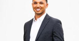 Professional portrait of Isaiah Denman, wearing a blazer and smiling confidently against a neutral background.