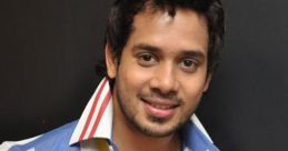 Bharath smiling in a colorful striped shirt, showcasing his stylish look against a dark background.