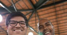 Two friends smiling together, showcasing camaraderie at a tech event, highlighting Tejas Kumar's engaging personality and connections.