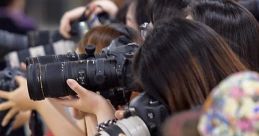 Crowd of photographers capturing moments, highlighting the excitement around Annisa Rahmaesra's public appearance.